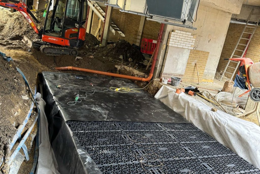 Geocellular attenuation crates being laid in the excavation, Beckenham