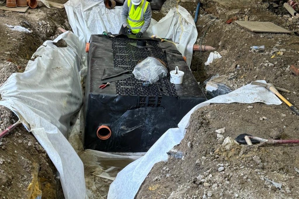 Attenuation tank wrapped in geomembrane with pipework connected, Beckenham