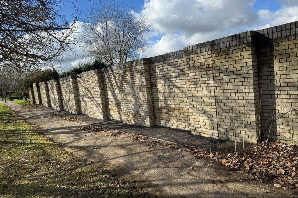 Completed blockwork retaining wall with piers along the boundary, Colchester