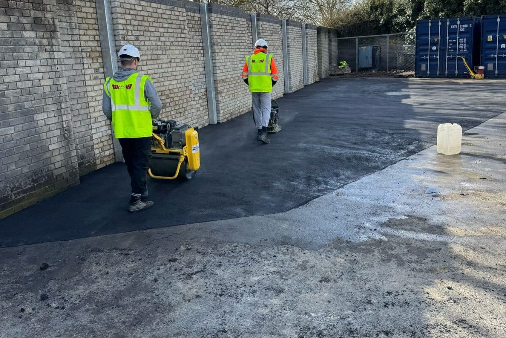 Compacting the reinstated surfacing beside the new wall, Colchester