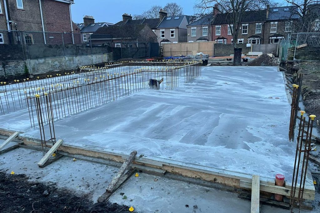 Reinforced concrete slab poured with starter bars to the perimeter, Lewisham